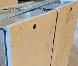 Close-up of a PanLbilt panel edge, showing the fiber cement board and cured foam cement core.
